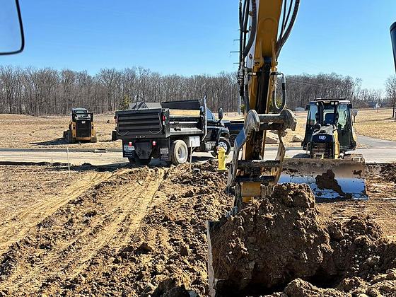 BDX excavator loading a dump truck on a commercial earthwork site